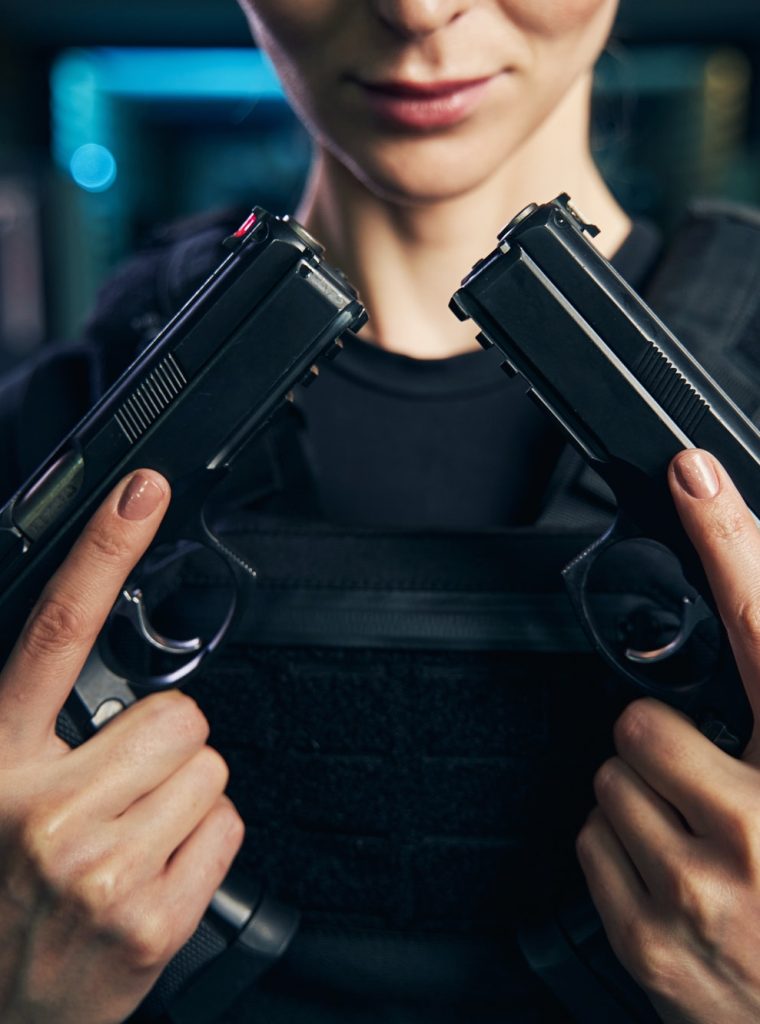 professional-caucasian-female-shooter-showing-her-two-handguns.jpg